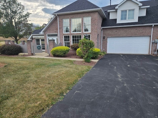 view of front of property with a garage and a front lawn