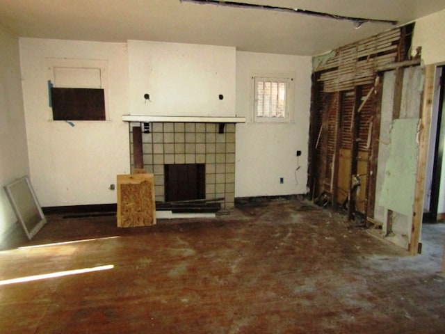 unfurnished living room with a tiled fireplace