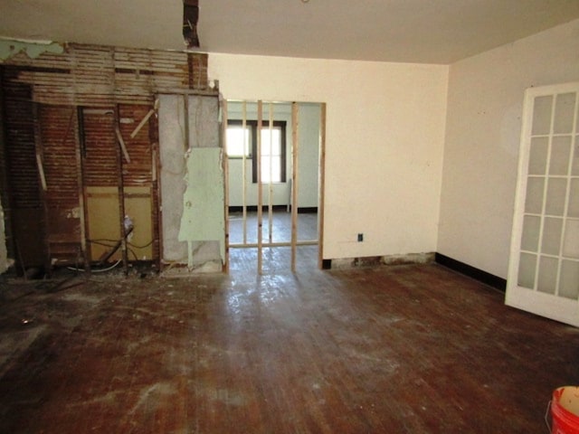 empty room with dark hardwood / wood-style flooring