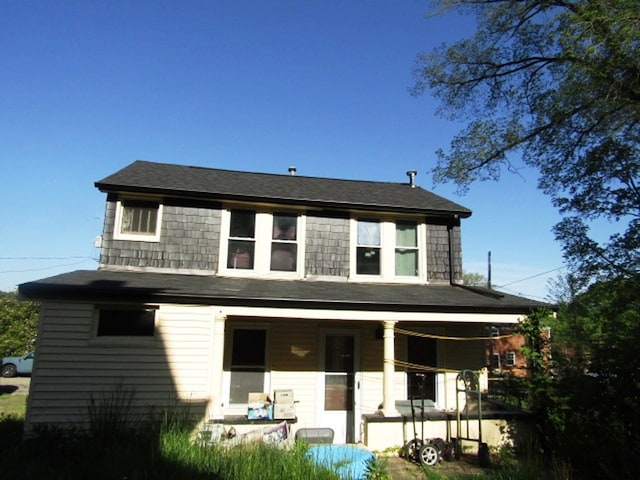 rear view of house featuring a porch