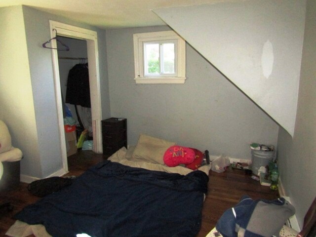 bedroom with a closet and hardwood / wood-style flooring