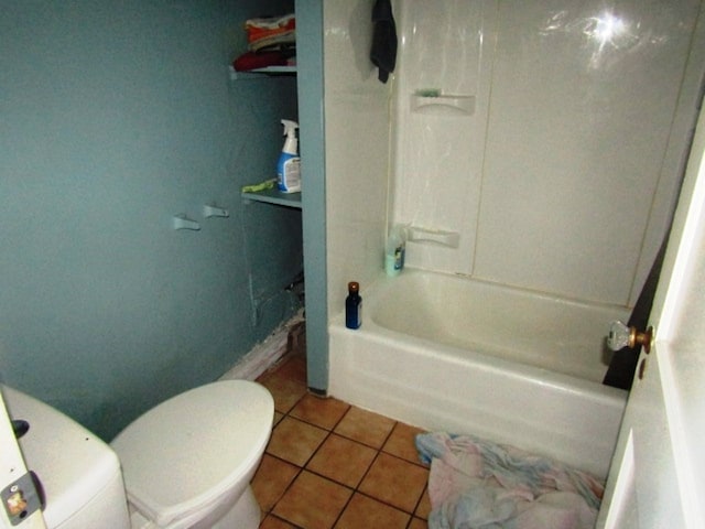 bathroom featuring tile floors, tub / shower combination, and toilet