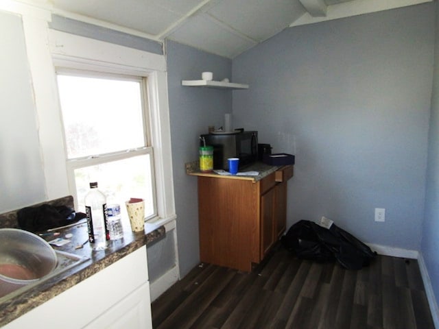 office space featuring vaulted ceiling and dark wood-type flooring