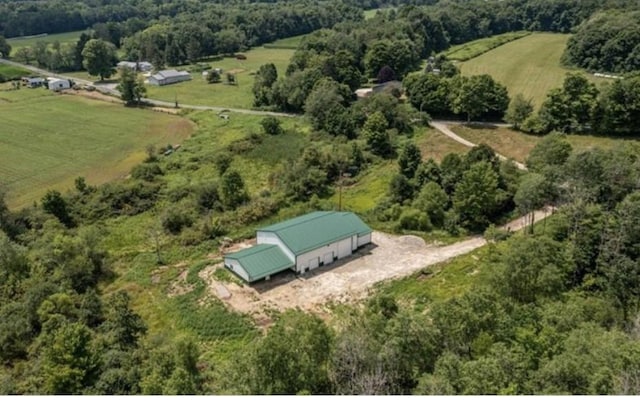 drone / aerial view with a wooded view and a rural view