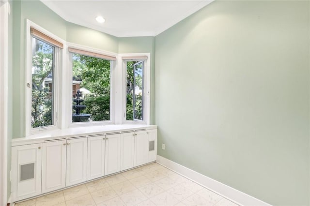 interior space with ornamental molding, recessed lighting, and baseboards