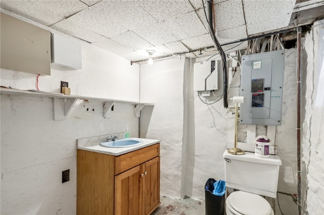 bathroom with toilet, electric panel, and vanity