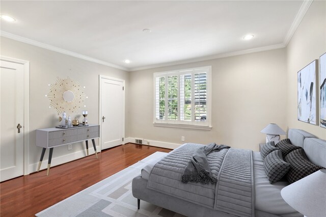 bedroom featuring hardwood / wood-style floors and crown molding