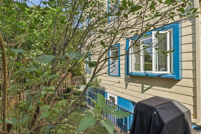 view of side of home featuring fence