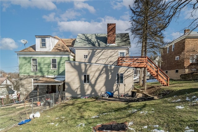 rear view of property featuring a lawn