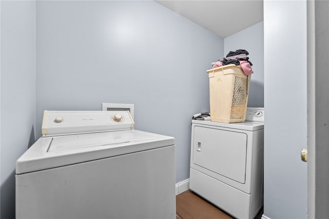 laundry area with wood-type flooring and washing machine and dryer