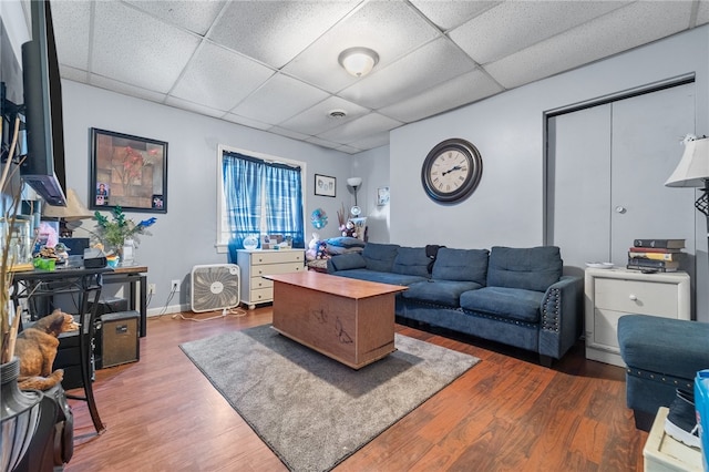 living room featuring hardwood / wood-style flooring and a paneled ceiling