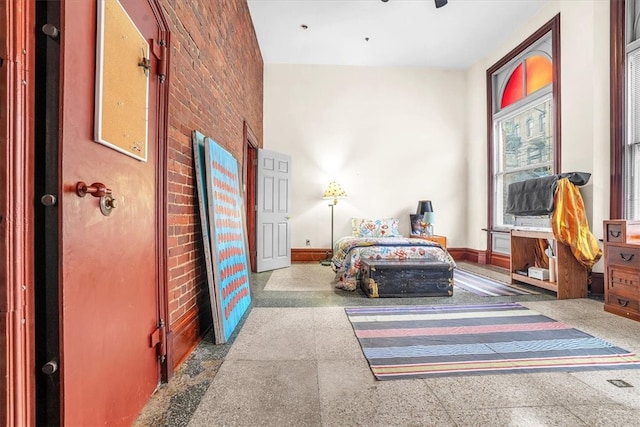 bedroom featuring brick wall