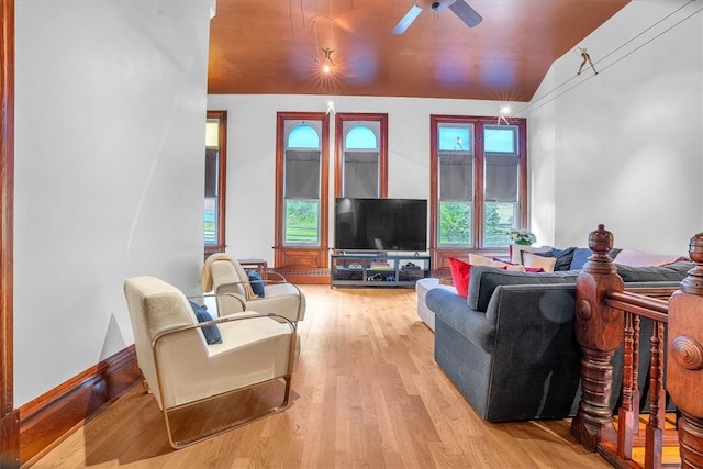 living room featuring hardwood / wood-style floors, vaulted ceiling, and ceiling fan