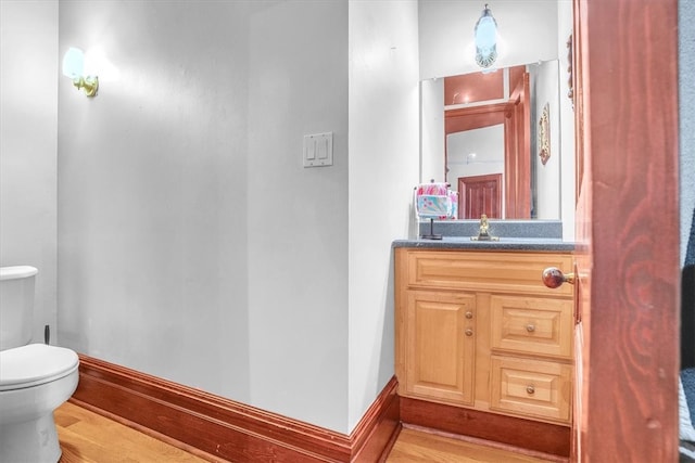 bathroom featuring hardwood / wood-style flooring, toilet, and large vanity