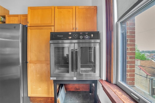 interior space featuring stainless steel appliances and tile flooring