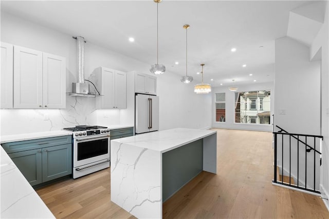 kitchen with high quality fridge, pendant lighting, white cabinets, a center island, and stainless steel gas range oven