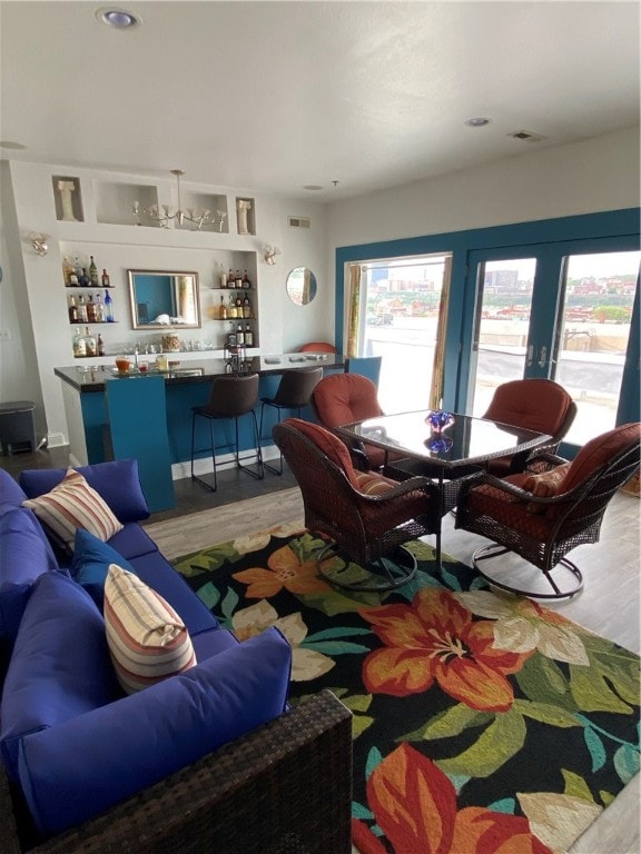 living room featuring light hardwood / wood-style flooring and bar