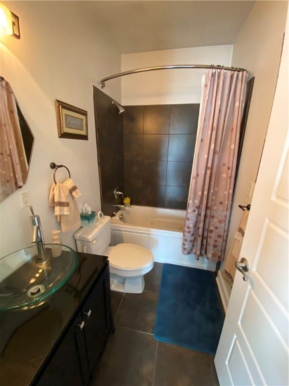 full bathroom featuring shower / tub combo with curtain, vanity, toilet, and tile patterned floors