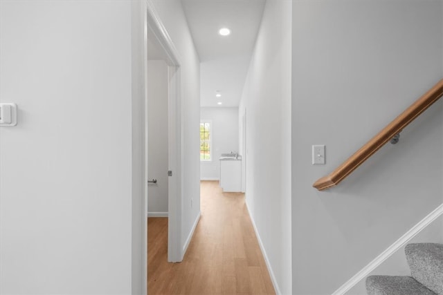 hallway with light hardwood / wood-style floors