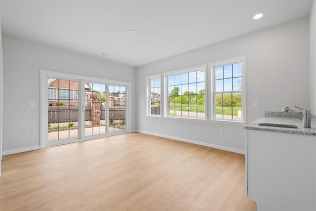 unfurnished room featuring sink and light wood-type flooring