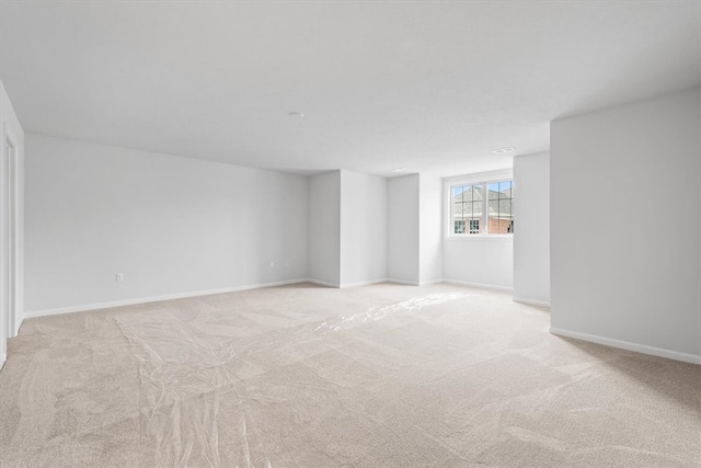 unfurnished room featuring light carpet