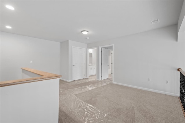 unfurnished room featuring light colored carpet