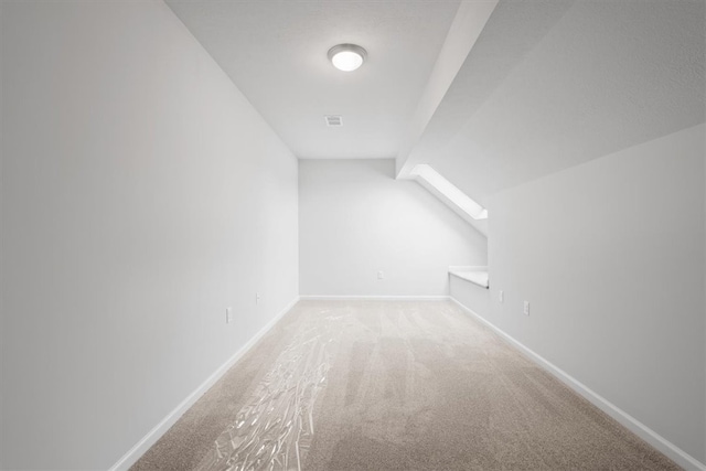 bonus room featuring vaulted ceiling and carpet