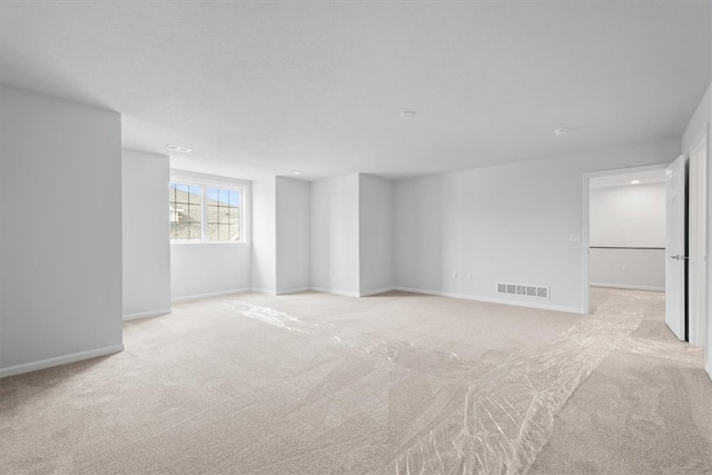 empty room featuring light carpet