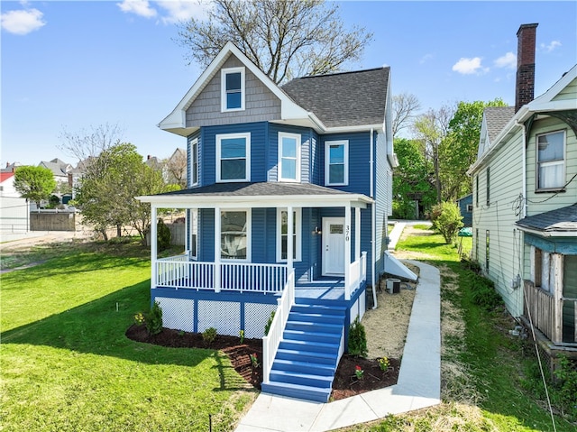 view of front facade featuring a front lawn and covered porch