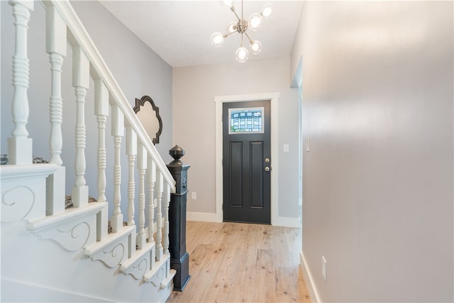 foyer with light wood-type flooring and a chandelier