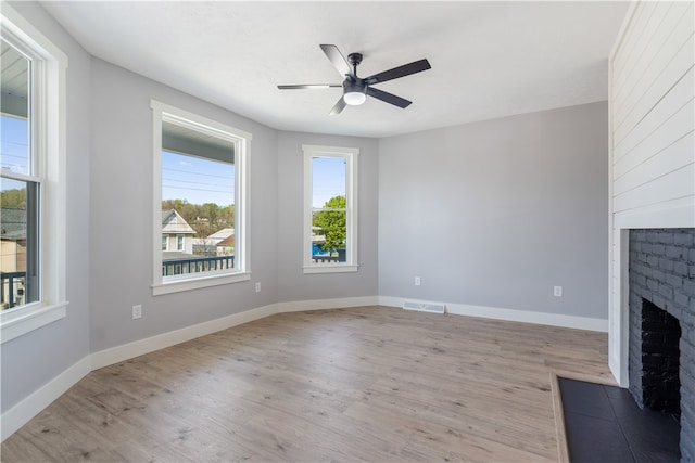 unfurnished living room featuring light hardwood / wood-style flooring and ceiling fan