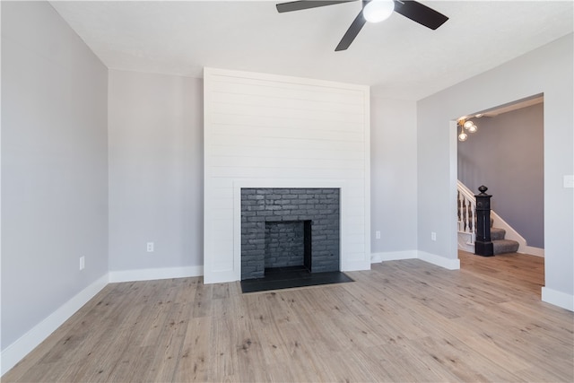 unfurnished living room with ceiling fan and light wood-type flooring