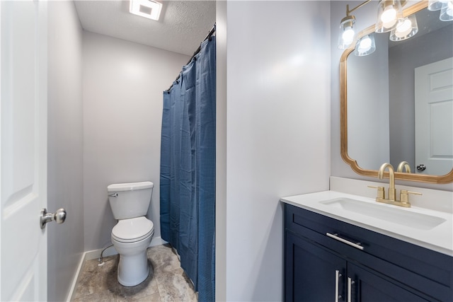 bathroom featuring tile flooring, vanity, toilet, and a textured ceiling