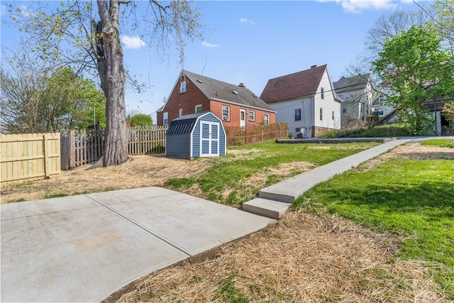 view of yard featuring a patio area and a storage shed