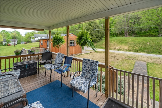 deck featuring an outdoor structure and a lawn