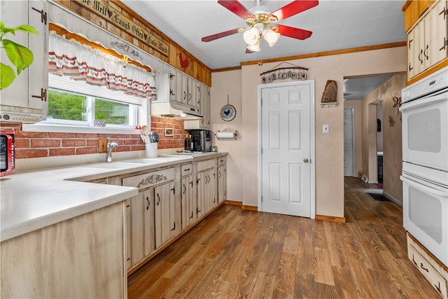 kitchen featuring light hardwood / wood-style flooring, white double oven, ceiling fan, and ornamental molding