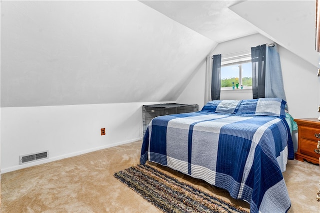 bedroom with lofted ceiling and carpet flooring