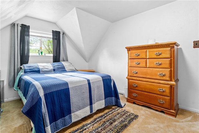 bedroom featuring carpet floors and vaulted ceiling