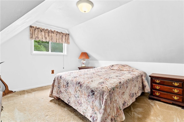 carpeted bedroom featuring lofted ceiling