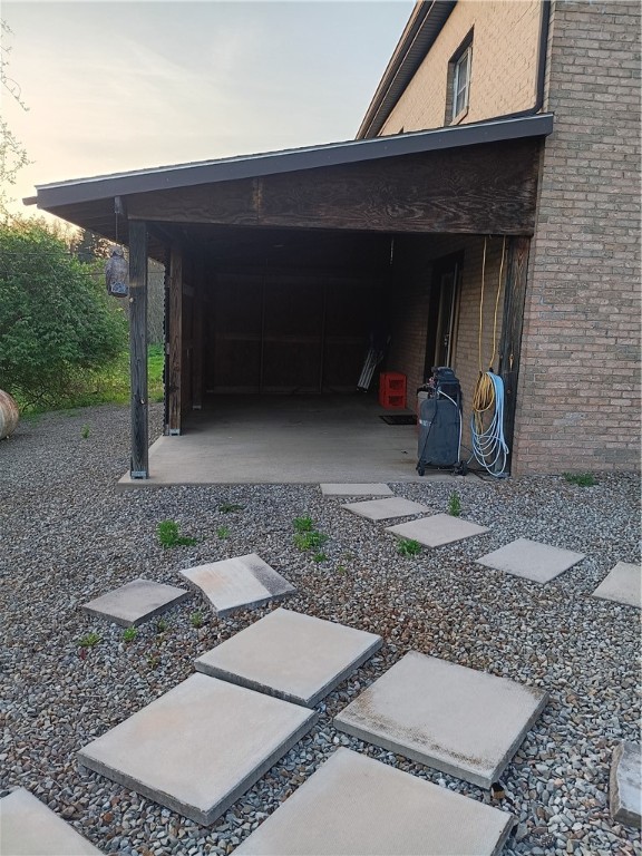 yard at dusk featuring a carport