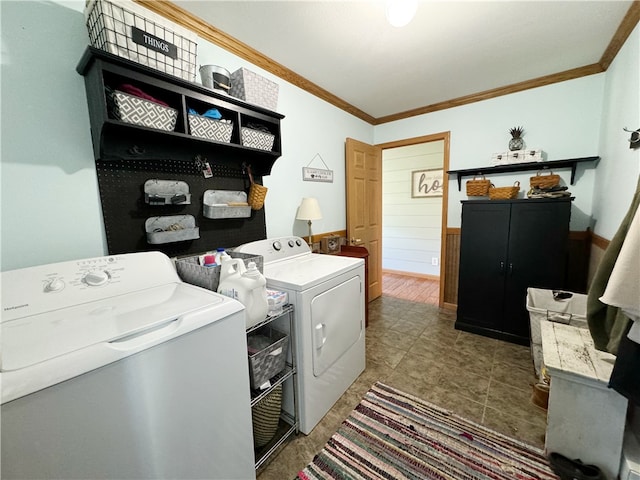 laundry area with crown molding, washer and clothes dryer, and tile floors