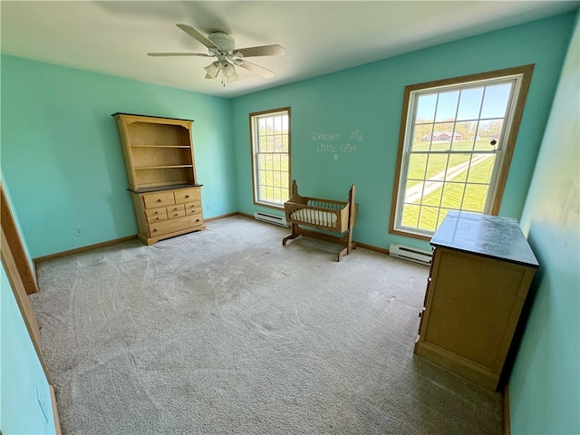 unfurnished room with a baseboard heating unit, carpet flooring, and ceiling fan