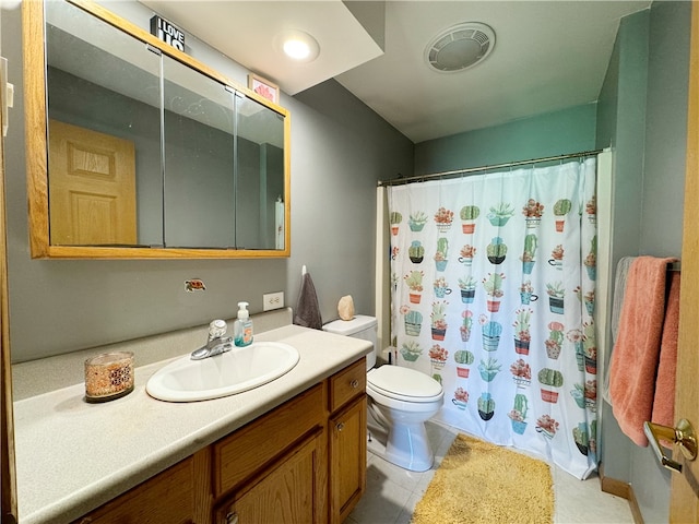 bathroom featuring tile flooring, toilet, and oversized vanity