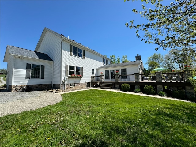 view of front of house featuring a front yard and a deck