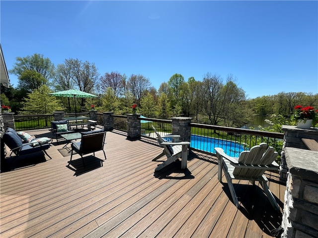 wooden terrace with a fenced in pool