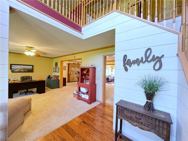 interior space featuring hardwood / wood-style floors, ceiling fan, and crown molding