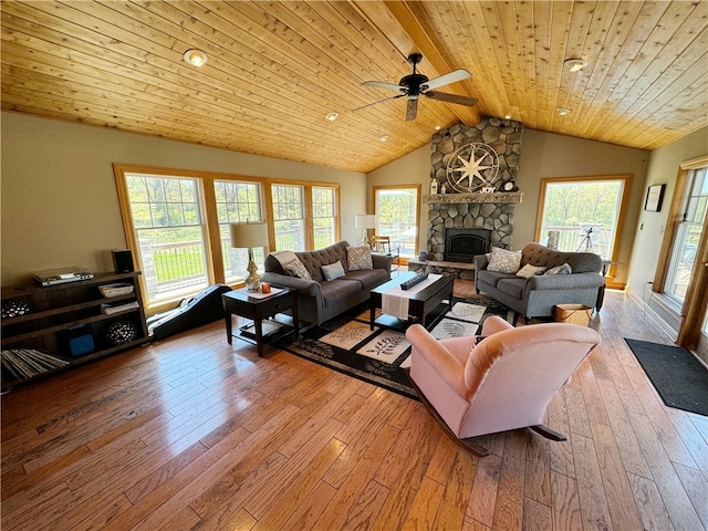 living room featuring a wealth of natural light, wooden ceiling, hardwood / wood-style floors, and a fireplace