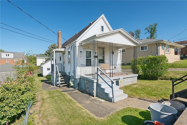 view of front of home featuring a front lawn and a porch