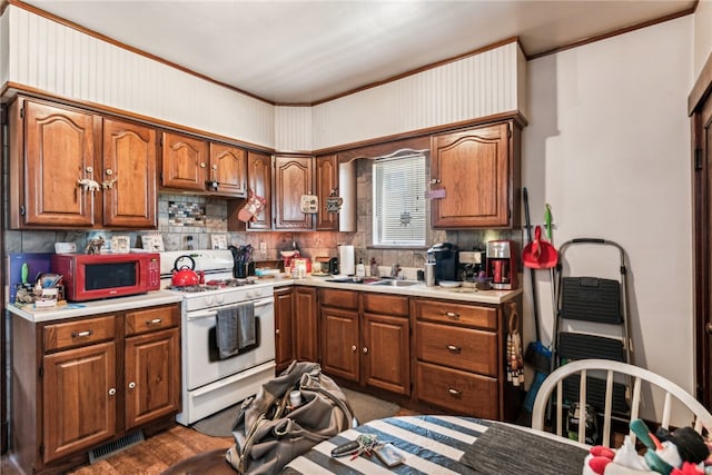 kitchen with sink, white appliances, and tasteful backsplash