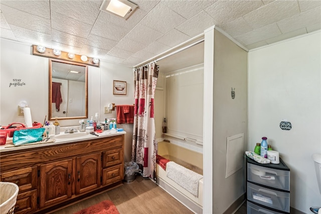 full bathroom featuring wood-type flooring, vanity, shower / tub combo, and toilet